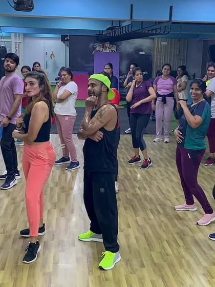 The class follows the instructor's lead, learning a new piece of choreography together.