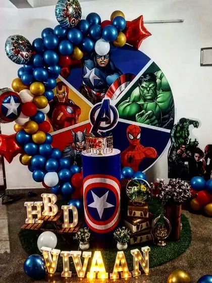 Avengers assemble! We created this epic Marvel Avengers theme for Vivaan's 3rd birthday. The backdrop features a wheel of heroes like Captain America, Hulk, and Iron Man, surrounded by a balloon garland and character standees.