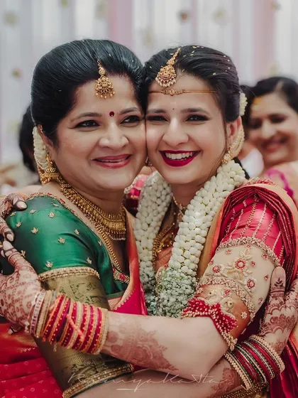 A beautiful moment between a bride and her mother, both adorned in my custom creations. I specialize in designing coordinated outfits that celebrate family bonds and create harmonious visual stories for your wedding day.
