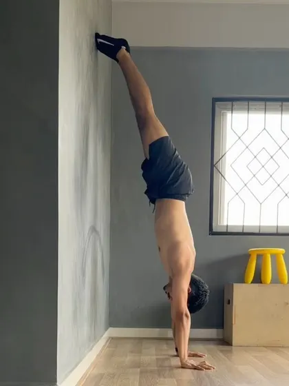 A new training phase means focusing on the fundamentals with the same grind. Here I am practicing a chest-to-wall hold, a staple in any handstand program for building a solid body line.