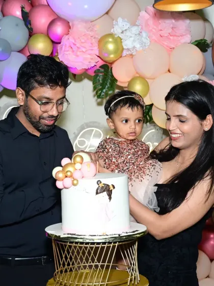 A family celebrates together at the cake table. These moments of shared joy are the heart of every party I plan.