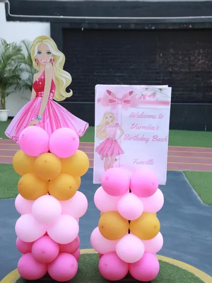 Welcome to Barbie's Dreamhouse! This welcome sign for Varnika's birthday bash features a Barbie cutout and pillars of pink and gold balloons, setting a glamorous tone.