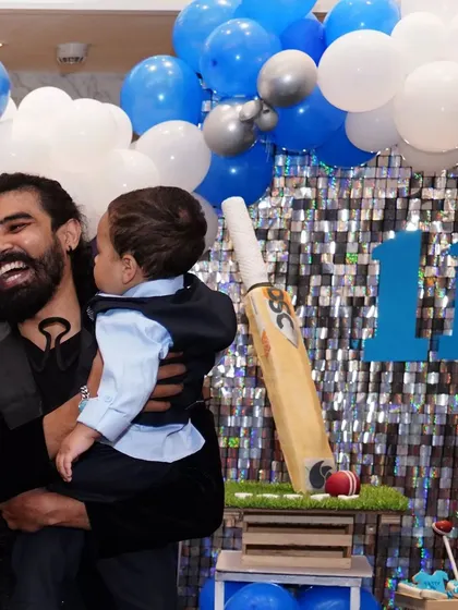 A happy moment holding the birthday boy at his cricket-themed party. It's a privilege to be part of such special family milestones.