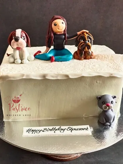 A special cake for a pet lover, featuring handcrafted fondant figures of her beloved dogs and cat.