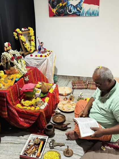 A senior member of our community participating in the Saraswati Pooja rituals. We are a community that spans all generations.