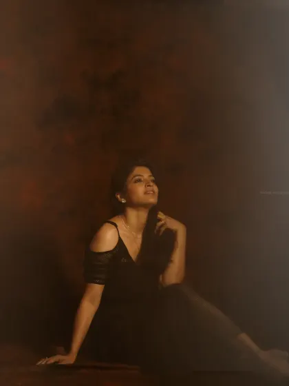 Another shot from the moody series, capturing a different pose. The low-key lighting and dark tones are consistent, creating a cohesive set.