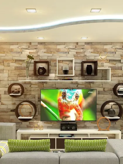 A living room design centered around a stone-clad accent wall for the TV unit. The floating shelves and curved ceiling with cove lighting add layers of visual interest.