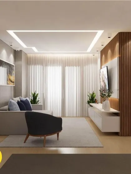 A minimalist living room with a simple TV unit, a comfortable sofa, and a sleek armchair. The focus is on clean lines and a clutter-free environment.
