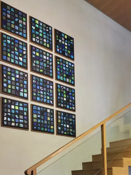 The final installation of the grid paintings, viewed from the top of the staircase.