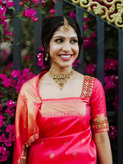 A duplicate of a previous image, a smiling portrait of the bride.