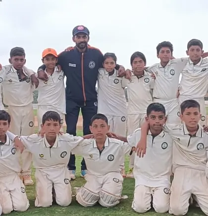 The U-12 team poses with their coach, a mix of boys and girls learning the game together.