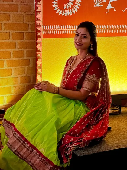 A lovely seated pose showing the comfort and grace of the langa voni. The rich colours and traditional border of the skirt stand out, making it a very photogenic outfit.