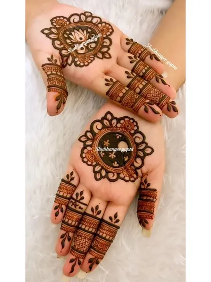 A minimal design perfect for Karwa Chauth or any festival. Each hand has a different central mandala, one with a lotus and one with a simple geometric pattern, showing that simple can still be beautiful.