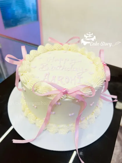 A lovely vintage-style cake decorated with delicate pink ribbons and bows. This coquette-style cake is very trendy and elegant.