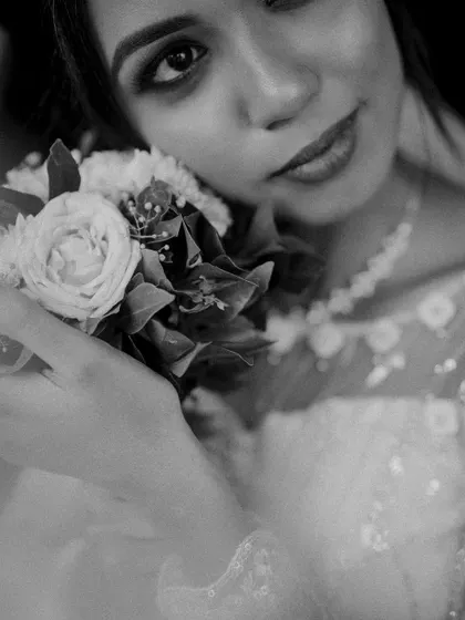 A close-up black and white shot of a bride holding her bouquet, creating an artistic and intimate portrait.
