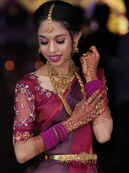 This pose beautifully showcases the detailed mehndi, the bangles, and the makeup, all coming together for a complete bridal look.
