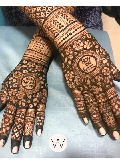 A complete view of the "Baby Coming Soon" design, with intricate floral patterns covering the hands.