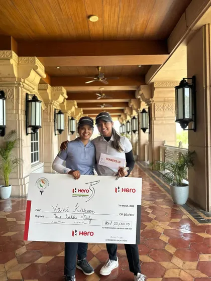 Rhea Jha celebrates her tied 2nd finish at Leg 5 of the Hero WPGT with winner Vani Kapoor, holding the prize check at the Classic Golf and Country Club.