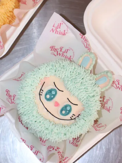 A mint-green Labubu character cake, showcasing the variety in our mystery box. The light blue color and sweet, sleepy eyes make this one a truly dreamy and adorable treat.