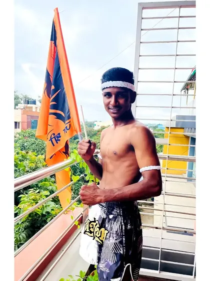 A student dressed in the traditional Mongkhon headwear and Pra Jiad armband, ready for his grading. This attire shows respect for the art and its history.