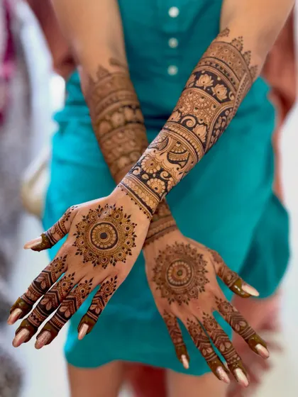 A modern bridal design featuring bold mandala patterns on the palms and forearms.