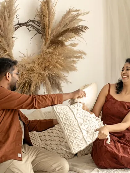 A playful moment between parents during a family photoshoot. Their spontaneous laughter shows that these sessions are not just for the kids, but a chance for the whole family to connect and have fun.