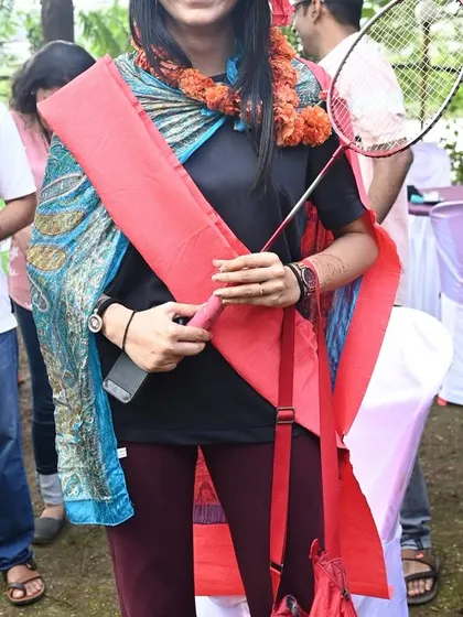 A participant proudly displaying her team's winning props after a game. I love to celebrate the winners and make everyone feel like they've accomplished something together.