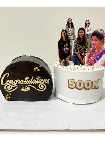 A set of two top forward cakes for a 500k celebration. One is a rich ganache cake and the other is a vanilla strawberry, showing the versatility of this style.