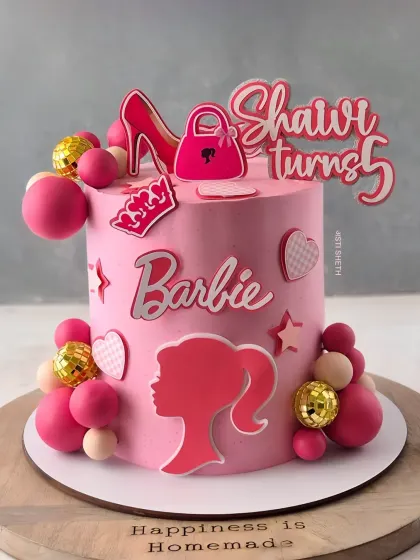 A stylish Barbie cake for a 5th birthday, featuring a silhouette and other fashion-themed toppers. This is a 1.5kg Fresh Strawberry Chocolate cake.