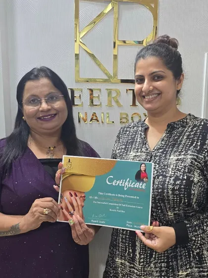 Presenting a certificate to a dedicated student who has successfully completed the nail extension course. Her journey is an inspiration, and I am excited to see her succeed.