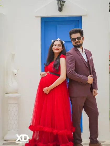 A stylish couple posing against the Santorini-inspired backdrop, exuding a cool and modern vibe.