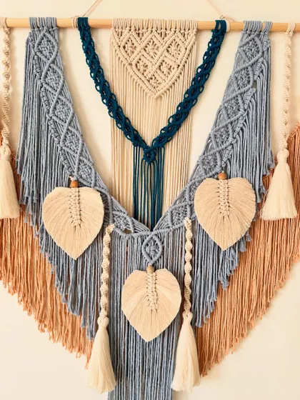 A detailed shot focusing on the beautiful knot patterns and the delicate macrame leaves.