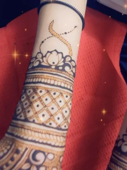 A close-up of the wristband detail, featuring a lotus and a checkerboard pattern.