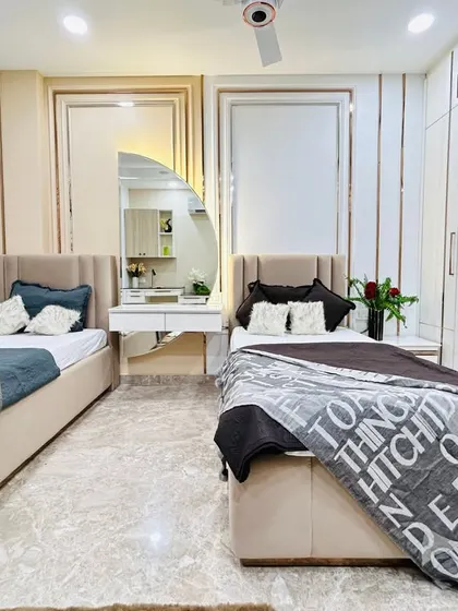 This view shows the twin beds, separated by a shared vanity unit with a modern, arched mirror. The design is perfect for teenagers, offering both personal space and a cohesive look.