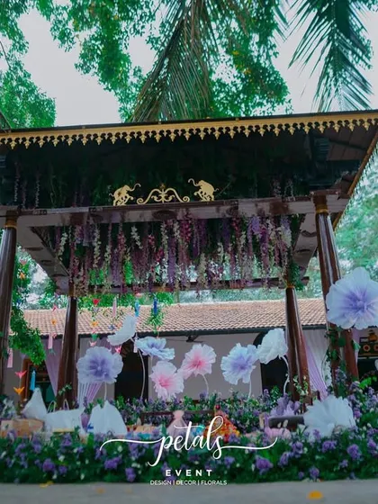 The Mehendi setup at The Tamarind Tree is a whimsical wonderland of organza blooms and origami birds. The traditional wooden structure is transformed into a pastel haven.