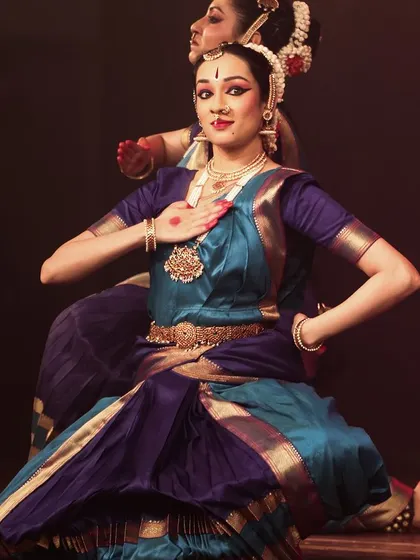 A dancer in a beautiful pose, showcasing the aesthetics of Bharatanatyam.