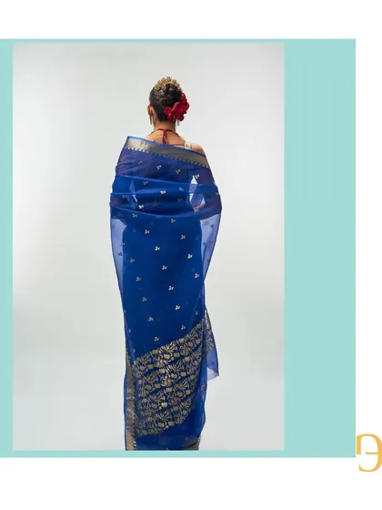 Another look at the back of the cerulean blue saree, showing the beautiful drape and the rich gold zari details.