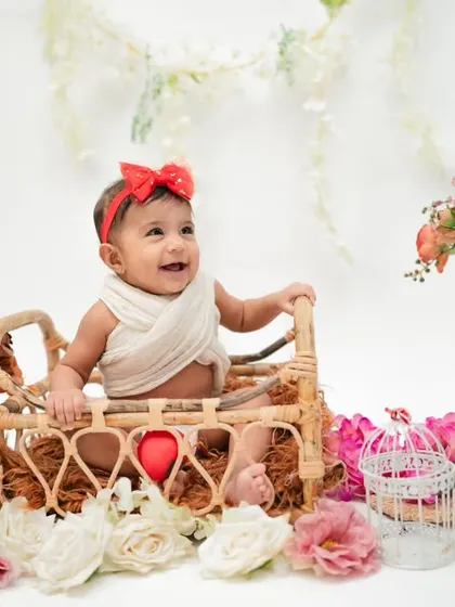 The world shines a little brighter with this sweet smile. Wrapped in love and surrounded by beauty, this little one is pure joy.