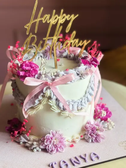 A Victorian-style cake that whispers elegance. This design features delicate ruffles, soft pastel palettes, and fresh floral accents for a birthday celebration that is minimal but not forgettable.
