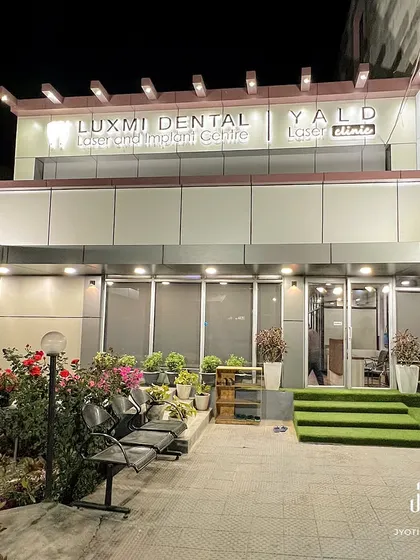 The completed exterior of Luxmi Dental Clinic. We renovated this old structure with modern materials and a clean facade, creating a professional and welcoming first impression for patients.