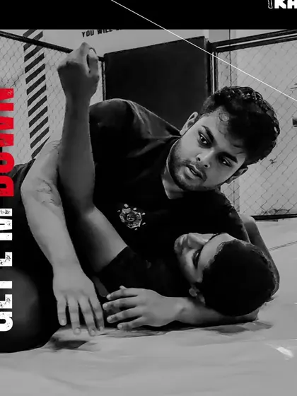 Get 'em down. A close-up shot of a grappling exchange, where one student works to secure a dominant position on the ground.