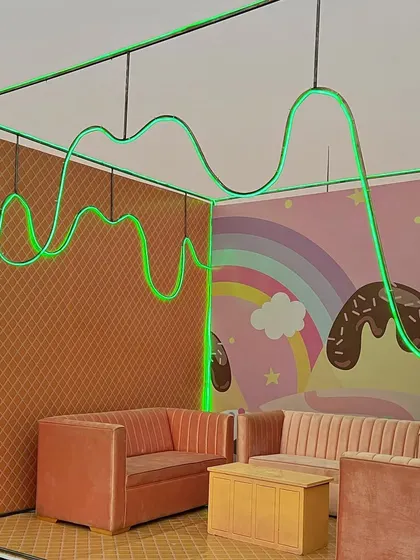 Another fun seating booth with neon green drizzle, offering a playful and comfortable spot for guests to relax.