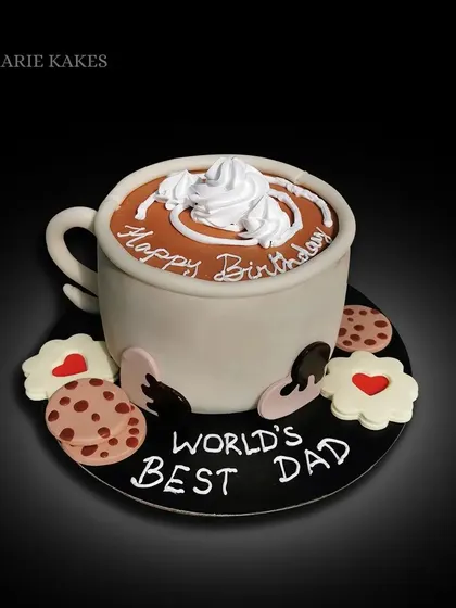 Anyone for a cup of coffee? This cake is sculpted to look like a giant coffee mug filled with coffee and whipped cream, complete with cookies on the side. A perfect cake for the "World's Best Dad".