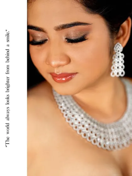A creative beauty portrait. The text overlay and the focus on the subject's smile and jewelry turn a simple headshot into a piece of graphic art.