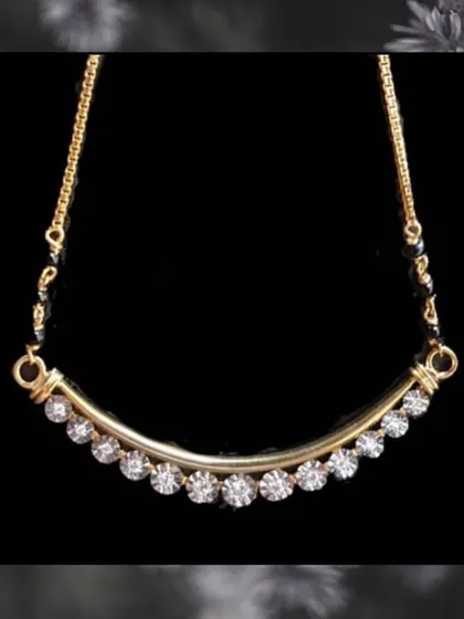 This design features a curved gold bar set with a line of round diamonds. It is a chic and minimalist take on the traditional mangalsutra, perfect for office or casual wear.