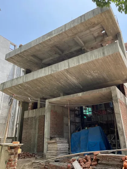 **Dwelling in Splits, Ahmedabad:** The concrete structure of the house, showcasing the staggered floor plates. This design creates a dynamic interior rhythm and allows for visual overlaps between different parts of the home.