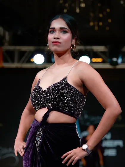 Another look at the embellished top and velvet skirt, highlighting the intricate beadwork.