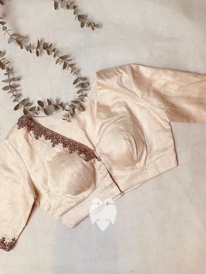 A minimal yet elegant off-white raw silk blouse.