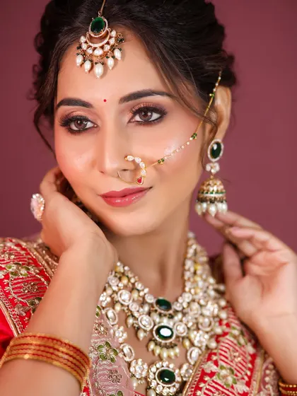 A close-up of a bridal lehenga look, showcasing the intricate kundan jewellery and the perfectly blended eye makeup.