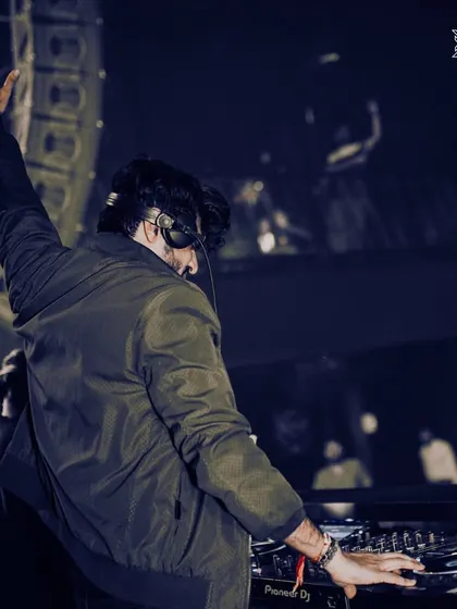 A classic DJ pose, hand in the air, getting the weekend party started. This is my call to the dance floor.